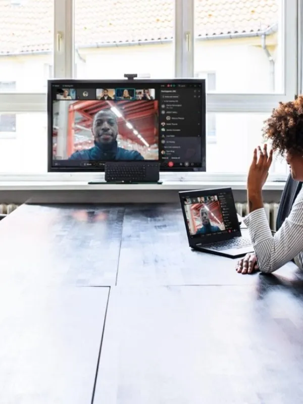 Meeting room video system showing a remote participant on a wall display